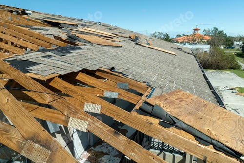 Preview: Ruined rooftop in need of repair. Wind damaged house roof with missing asphalt shingles