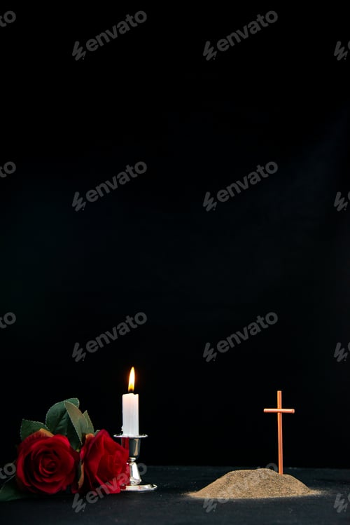 Preview: little grave with candle and flowers as memory on a dark surface funeral palestine israel death