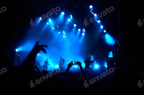 Preview: Hand with a phone records live music festival. People taking photographs with smart phone concert.