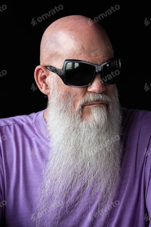 Preview: Portrait of man with long gray beard wearing purple t-shirt and sunglasses close-up shot