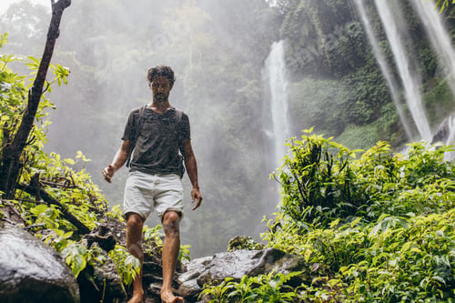 Preview: Male hiker walking down the mountain trail