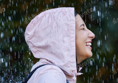 Preview: The rain makes me feel alive. Shot of an attractive young woman standing alone outside in the rain.
