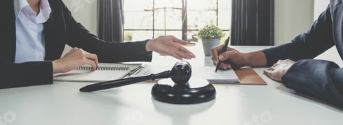 Preview: Business woman and lawyers discussing contract papers with brass scale on wooden desk in office. Law