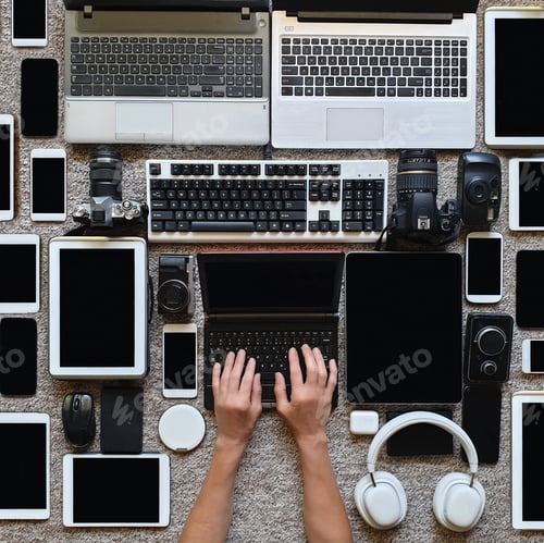Preview: person using technology surround with multiple devices