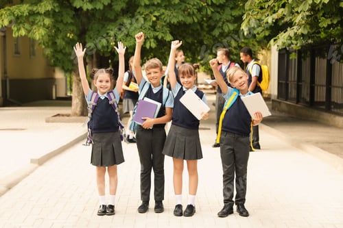 Preview: Little children in stylish school uniform outdoors