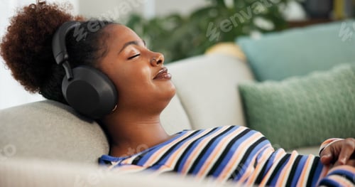 Preview: Headphones, relax and calm woman on sofa listening to music, radio or podcast in living room. Audio