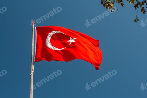 Preview: National flag with white star and moon on a pole in sky