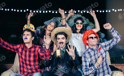 Preview: Happy friends having fun with costumes in a party