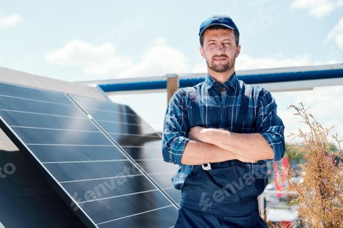 Technician Standing Near Solar Panels on Sunny Day