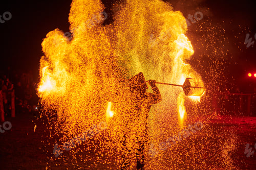 Preview: Silhouette of Two Fire Performers Creating Sparks Against Night field