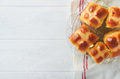 Preview: Easter hot cross buns with colored eggs, Easter gingerbread rabbits and cookies over white plank woo