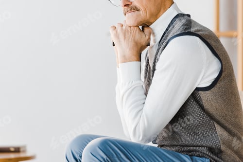 Preview: cropped view of sad pensioner sitting at home