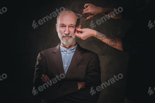 Preview: Woman barber cutting hairs of elegant elderly man