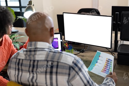 Preview: Rear view of diverse male and female designers using computer with copy space in office