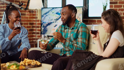 Preview: Man discussing with multiethnic apartment party guests about his girlfriend