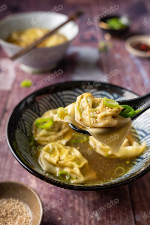 Preview: Side view of two bowls of home made vegan wonton soup with tofu and broccoli