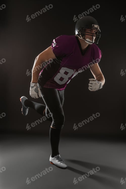 Preview: American football player wearing uniform on dark background