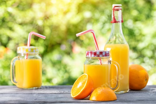 Preview: Refreshing Orange Juice in Mason Jars Outside