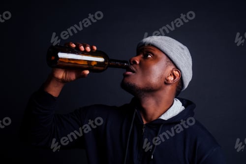 Preview: african american gue wearing gray hat and hoody hjlding botle with wine