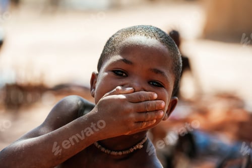 Preview: Namibia, Africa - June 14, 2021: Child of the ethnic people of Africa is outdoors