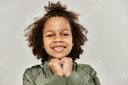 Preview: Enchanting moment: little girl in green jacket poses