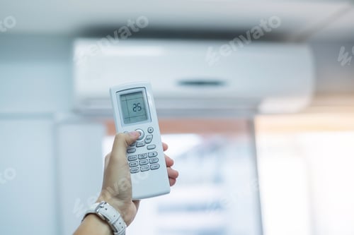 Preview: hand using remote controller for adjust Air conditioner