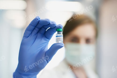 Preview: Ampule with coronavirus held by a doctor