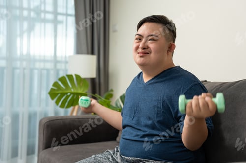 Preview: Portrait of Asian young man down syndrome exercise for health in house.