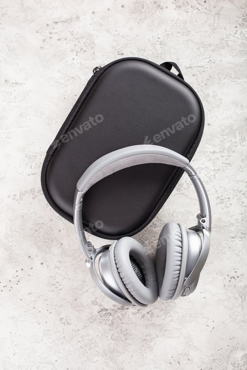 Preview: modern silver wireless headphones on concrete background