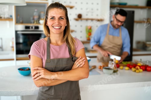 Preview: Healthy food at home. Happy woman is preparing organic bio meal in the kitchen.