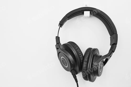 Preview: Headphone hanging on a white wall. Music background. Audio equipment