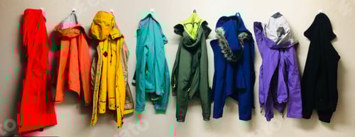 Preview: Rainbow jackets hung up on wall