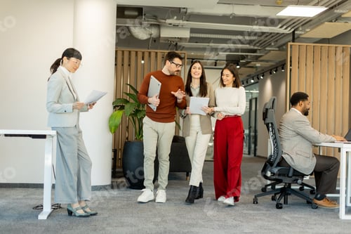 Preview: Collaborating in a modern office environment during a busy workday with creative discussions