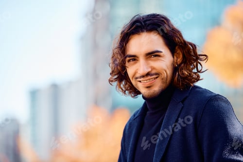 Preview: Portrait of smiling Latin American entrepreneur outdoors looking at camera.