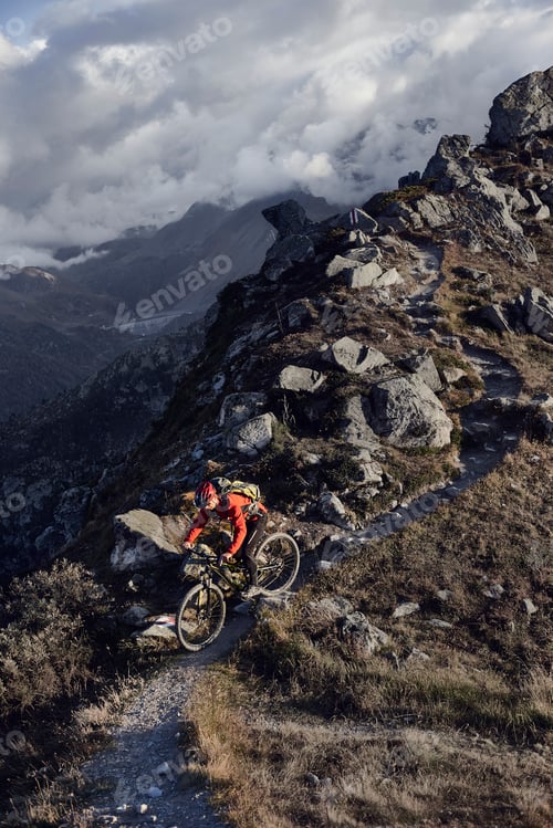 Preview: Mountain biker on dirt track, Valais, Switzerland