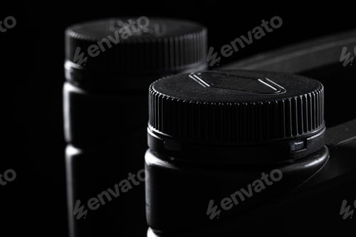 Preview: Engine oil bottle on black background, close up