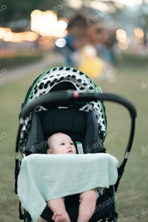 Preview: Asian mother lovingly holds her smiling baby, capturing heartfelt family moment the deep bond
