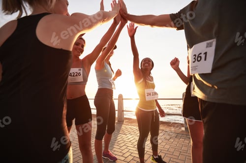 Preview: Runners high fiving each other after a race