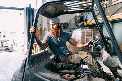 Preview: Man reversing fork lift out of warehouse