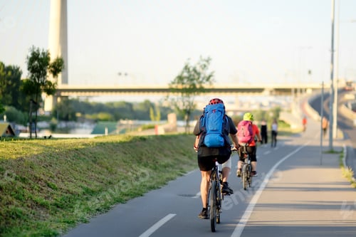 Preview: Sportive couple cycling by Ada Bridge over the Sava river in Belgrade, Serbia