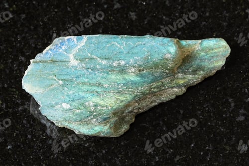 Preview: sample of raw green labradorite mineral on black