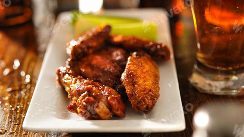 Preview: bbq chicken wings with celery on plate