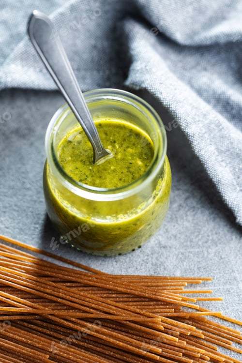 Preview: Fresh green basil pesto in jar.