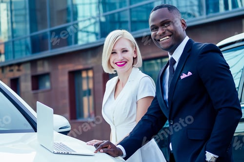 Preview: handsome African American businessman in a stylish black suit and attractive blonde