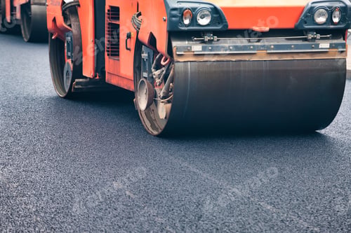 Preview: Asphalt Paving Machinery Conducts Road Repair in Urban Area Under Clear Blue Sky
