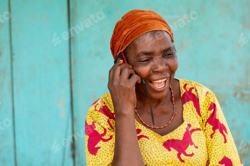 Preview: excited elderly african woman making a phone call