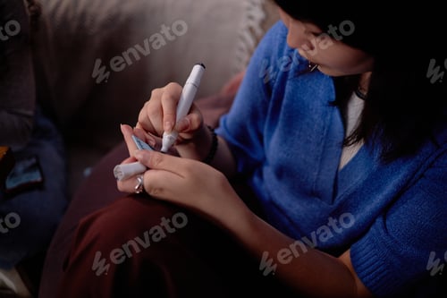 Preview: Asian Woman Writing with Pen in Indoor Setting