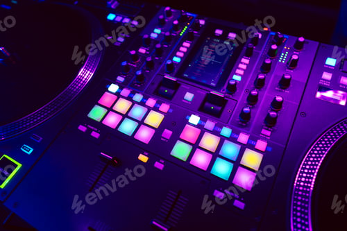 Preview: Close up of DJ mixing console in party light