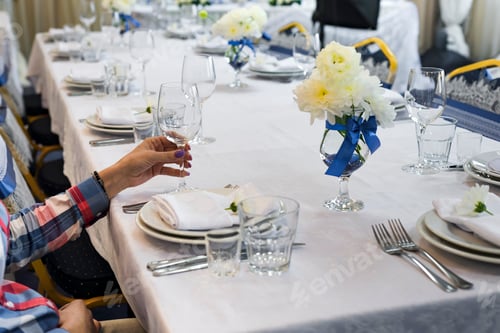 Preview: the woman is holding a glass in her hand