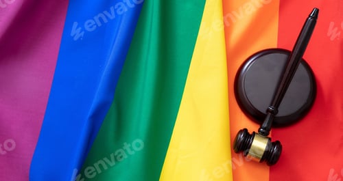 Preview: LGBT Law, Gay marriage. Judge gavel on rainbow color textile, overhead, Transgender rights